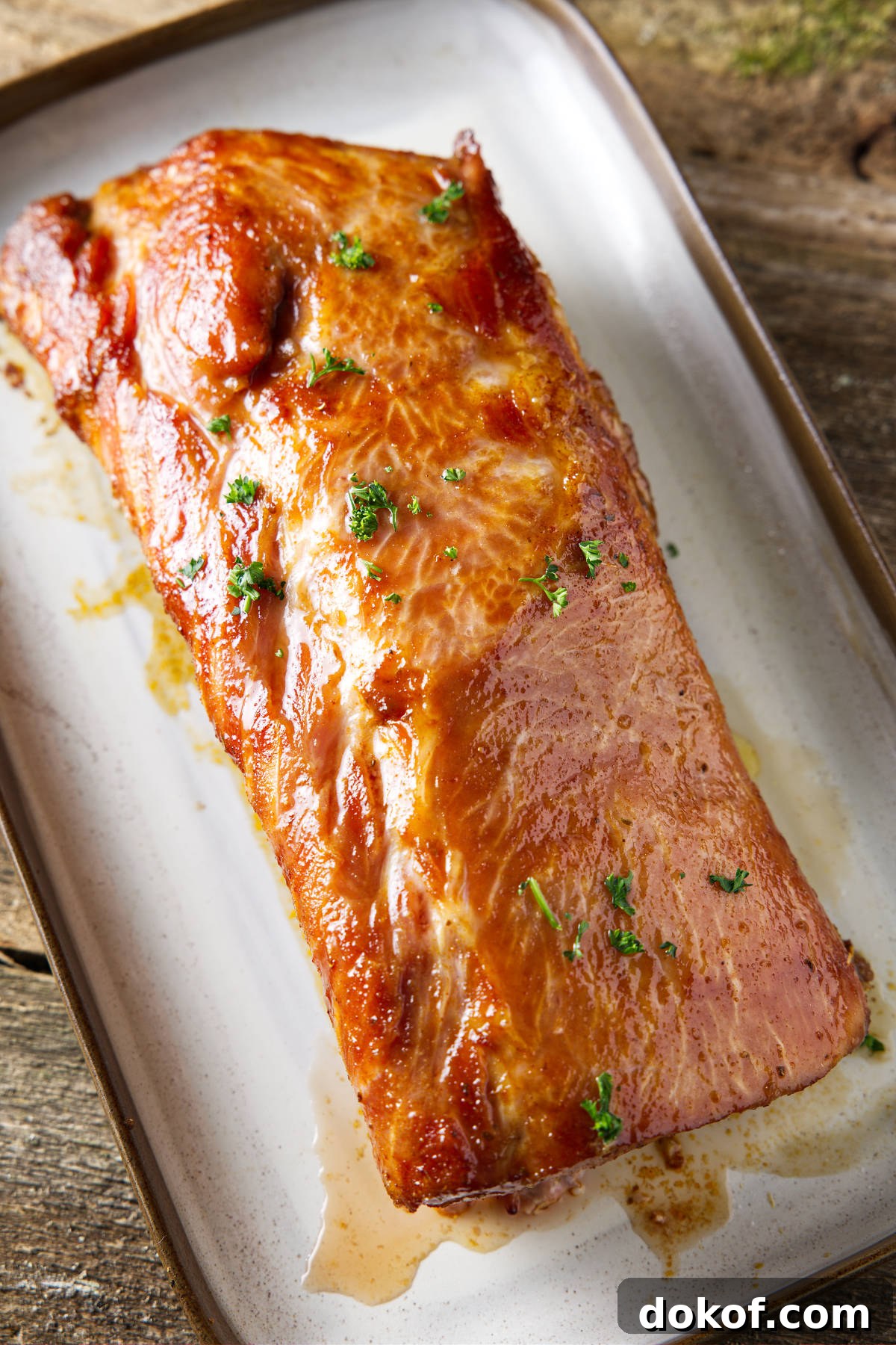 whole smoked pork loin resting on plate