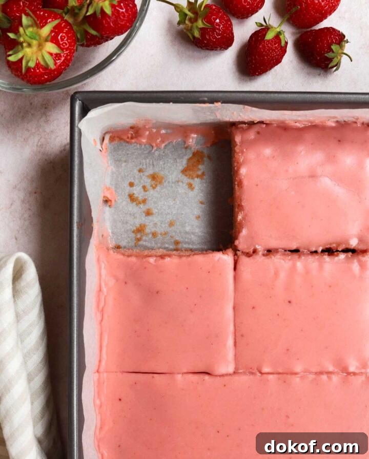 Fresh Strawberry Sheet Cake Recipe — Moist, Fruity Dessert 3 strawberry sheet cake with strawberry icing sliced in baking pan