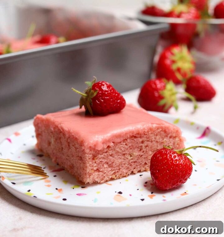 Fresh Strawberry Sheet Cake Recipe — Moist, Fruity Dessert 20 slice of strawberry sheet cake on a plate with fresh strawberries