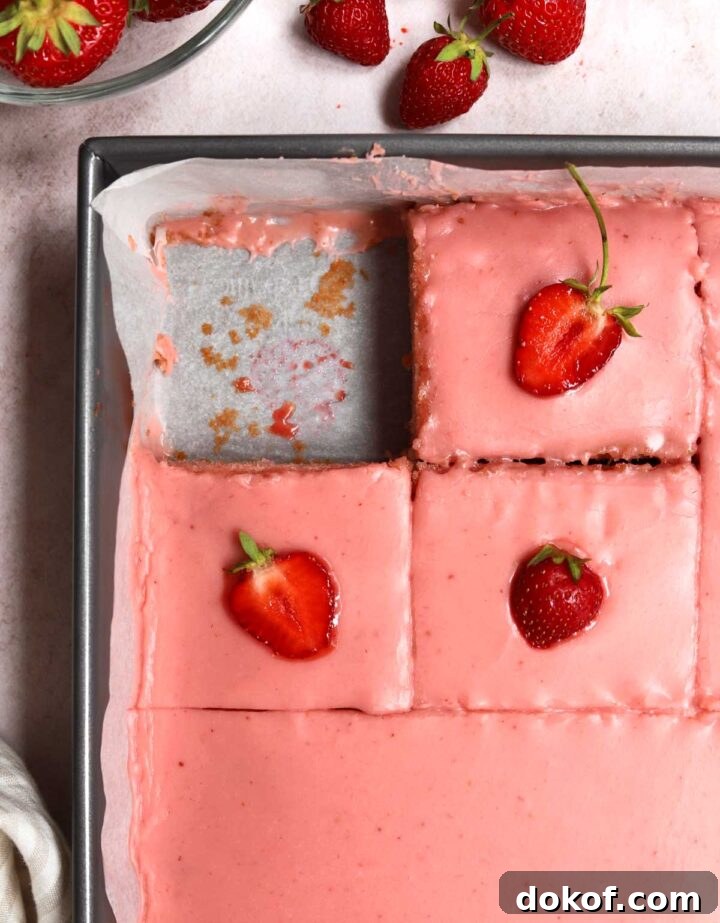 Fresh Strawberry Sheet Cake Recipe — Moist, Fruity Dessert 21 strawberry sheet cake with strawberry icing sliced in baking pan with fresh strawberries