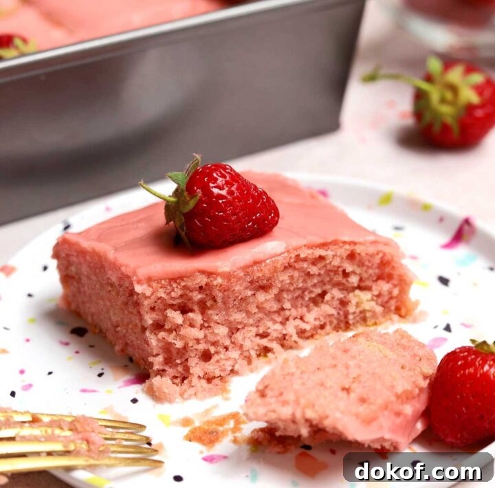 Fresh Strawberry Sheet Cake Recipe — Moist, Fruity Dessert 24 slice of strawberry sheet cake on a plate with bite and fork