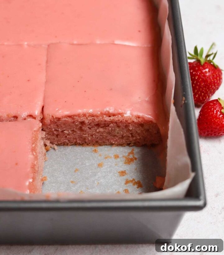 Fresh Strawberry Sheet Cake Recipe — Moist, Fruity Dessert 5 strawberry sheet cake with strawberry icing sliced in baking pan
