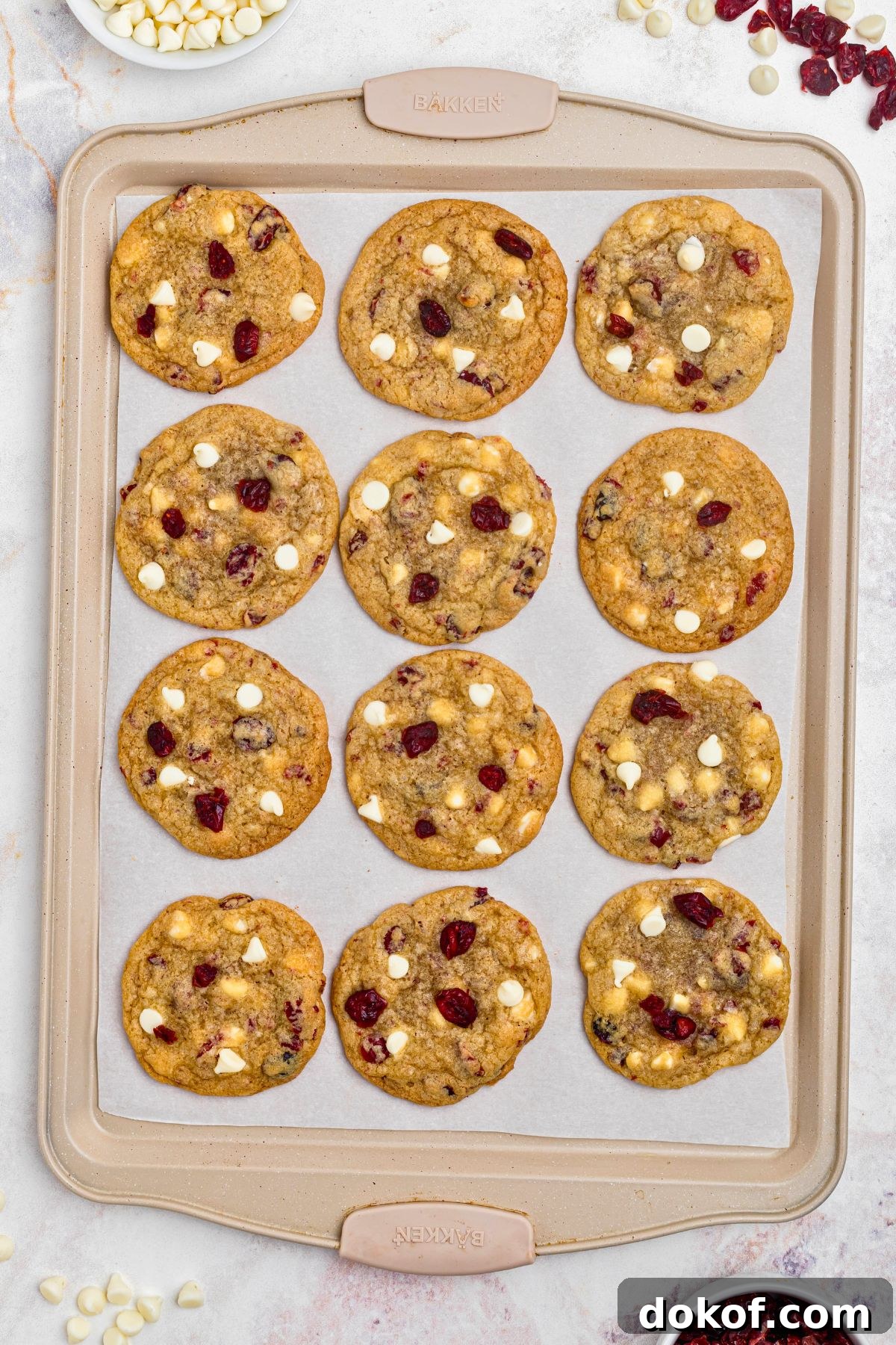 Baked cookies on a cookie sheet lined parchment paper. 