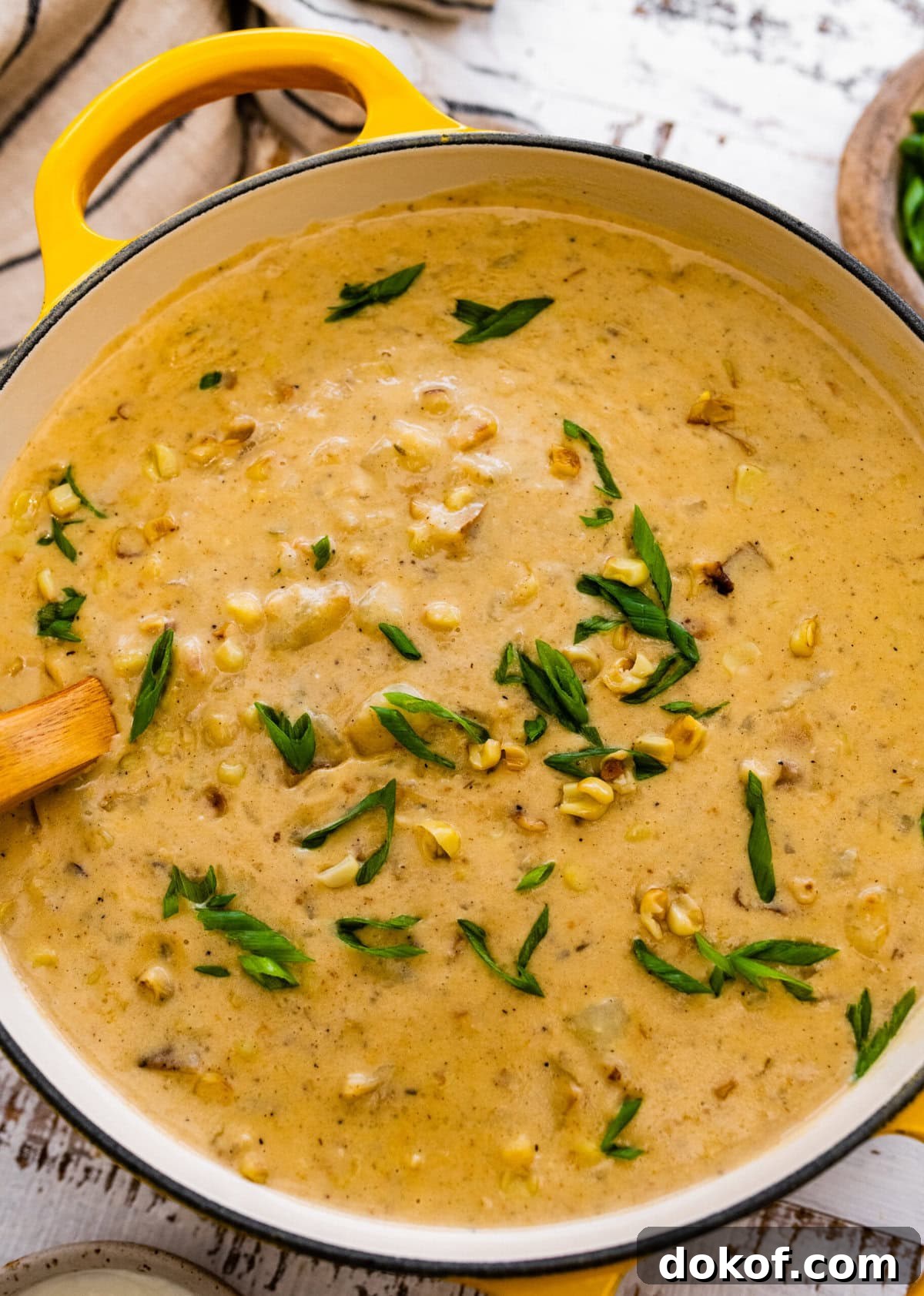 potato corn chowder recipe in a soup pot with a ladle ready to serve.