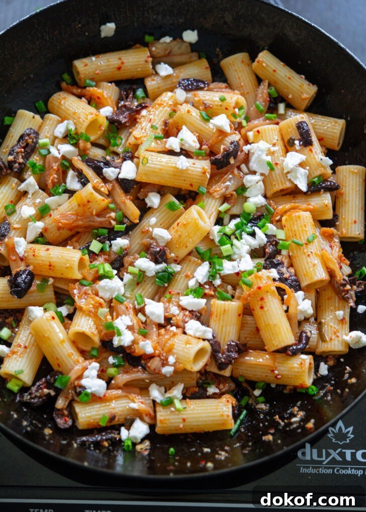 Feta cheese and green onion are added to kimchi olive pasta