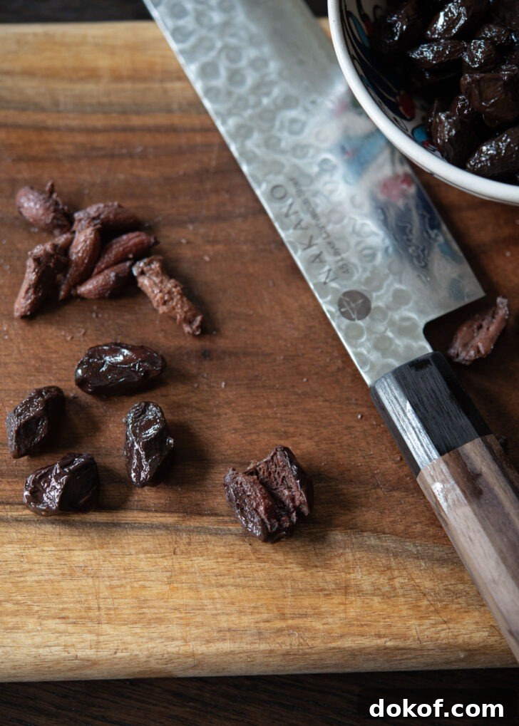 Pits are removed from olives using a knife.