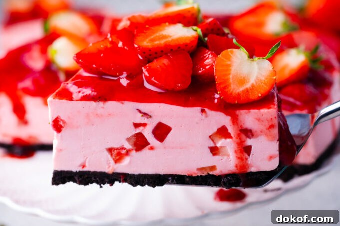 Homemade no-bake strawberry cheesecake with strawberry topping and an Oreo crust.