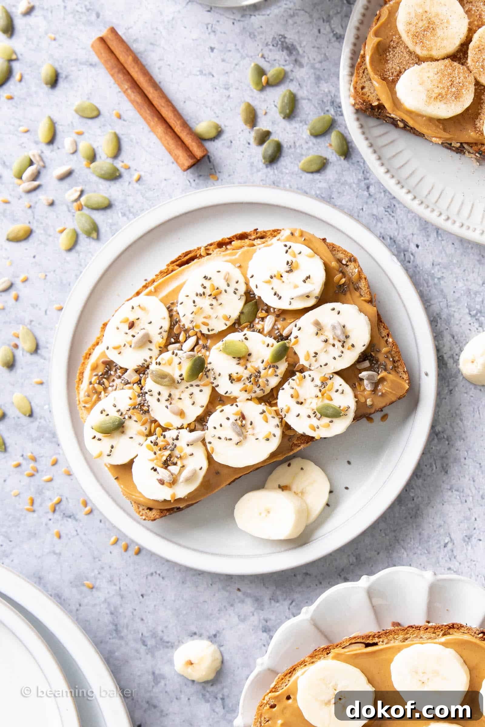 plate of peanut butter banana toast topped with seeds