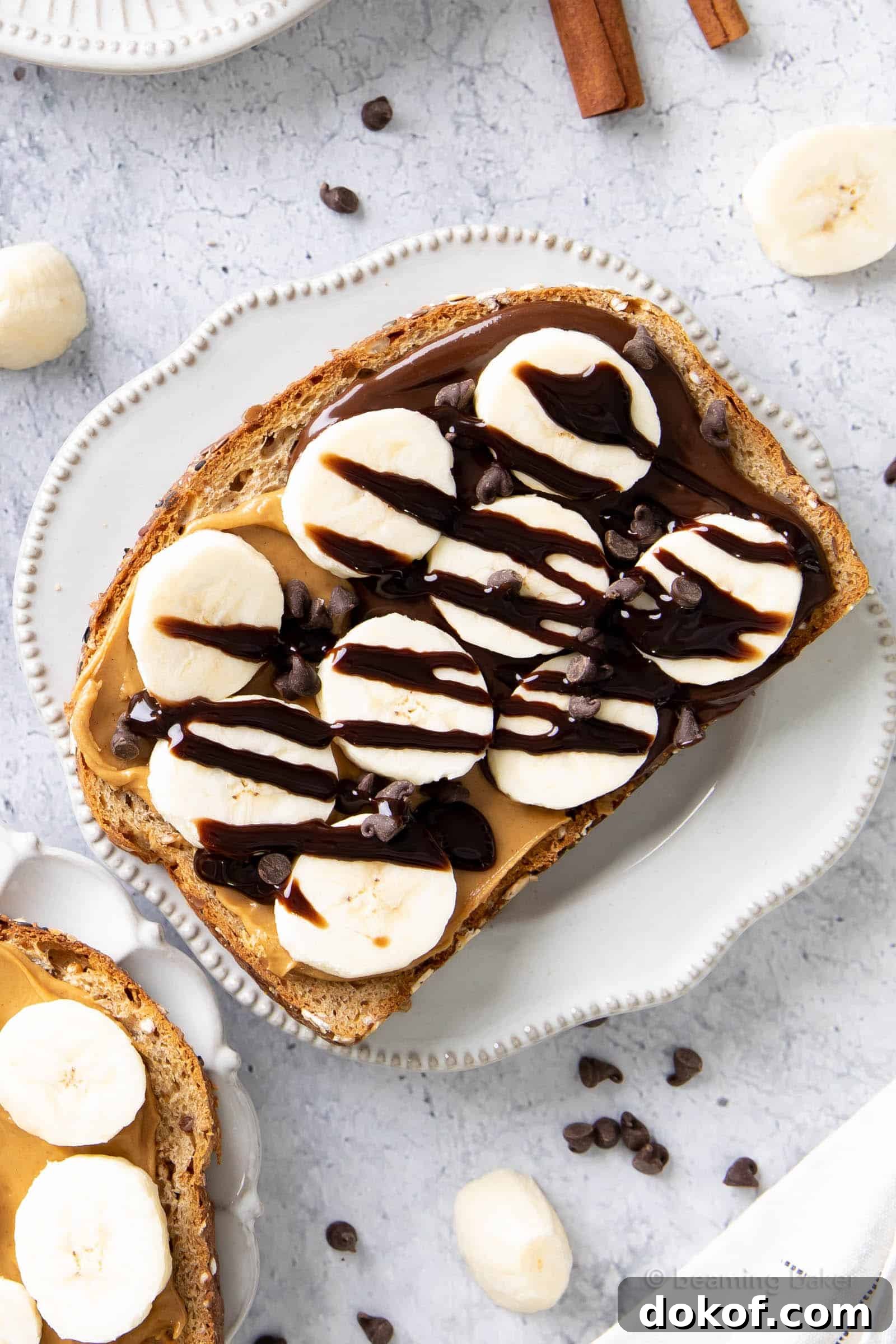 chocolate peanut butter and banana toast topped with chocolate syrup