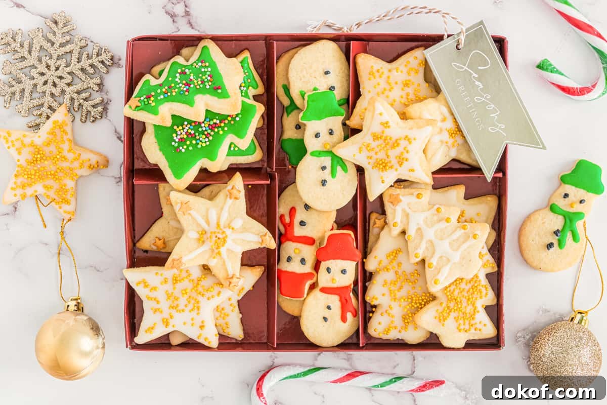 Christmas tree, snowman, and star shaped Cut out Christmas cookies arranged in serving box