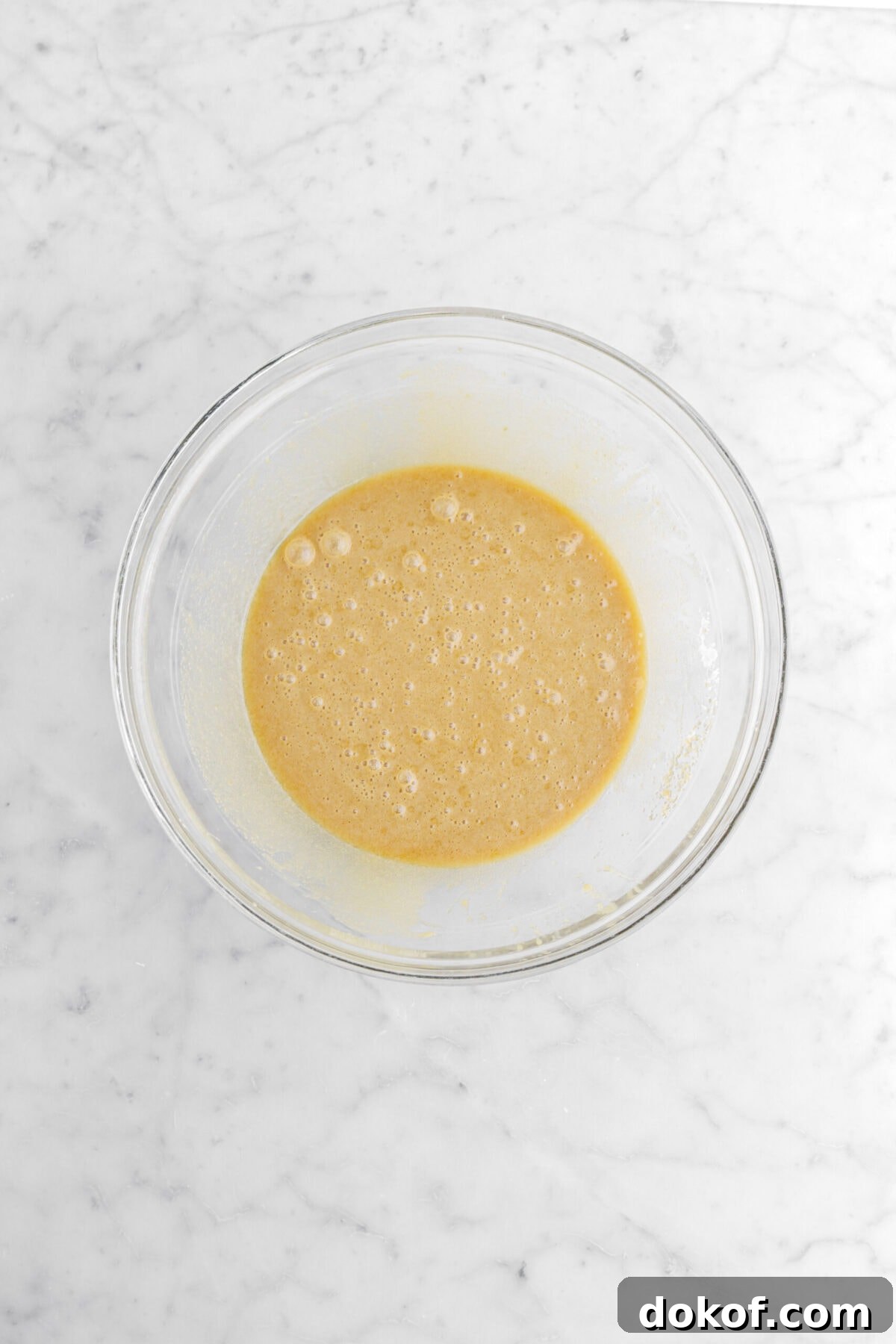 wet ingredients whisked together in glass bowl.