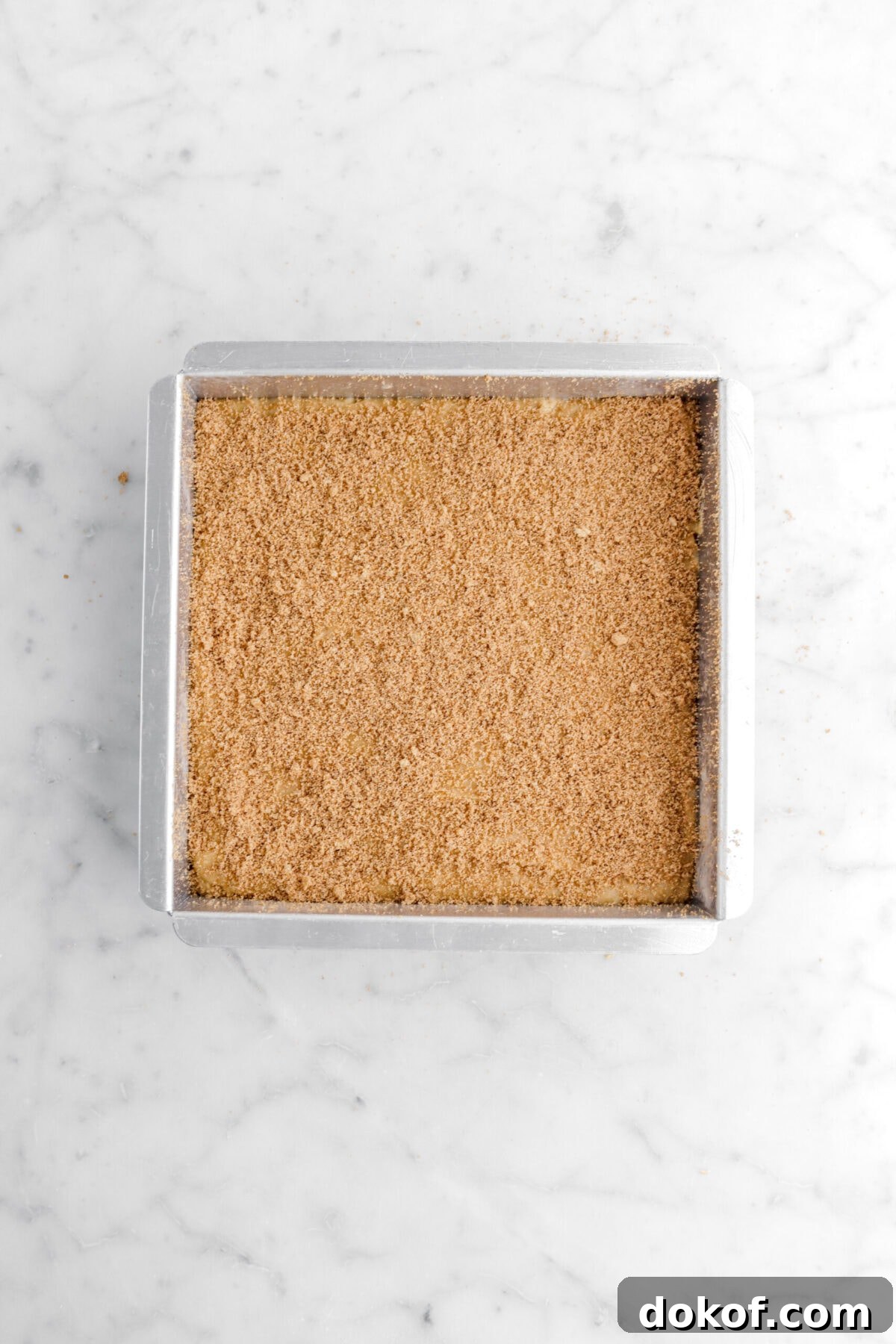 blondie batter in square pan with cinnamon sugar on top.