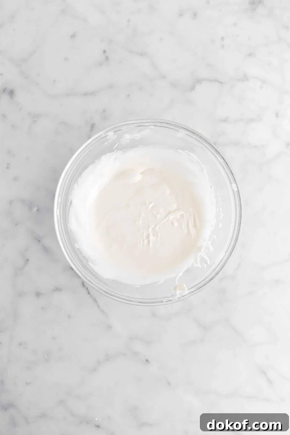 vanilla icing in glass bowl.