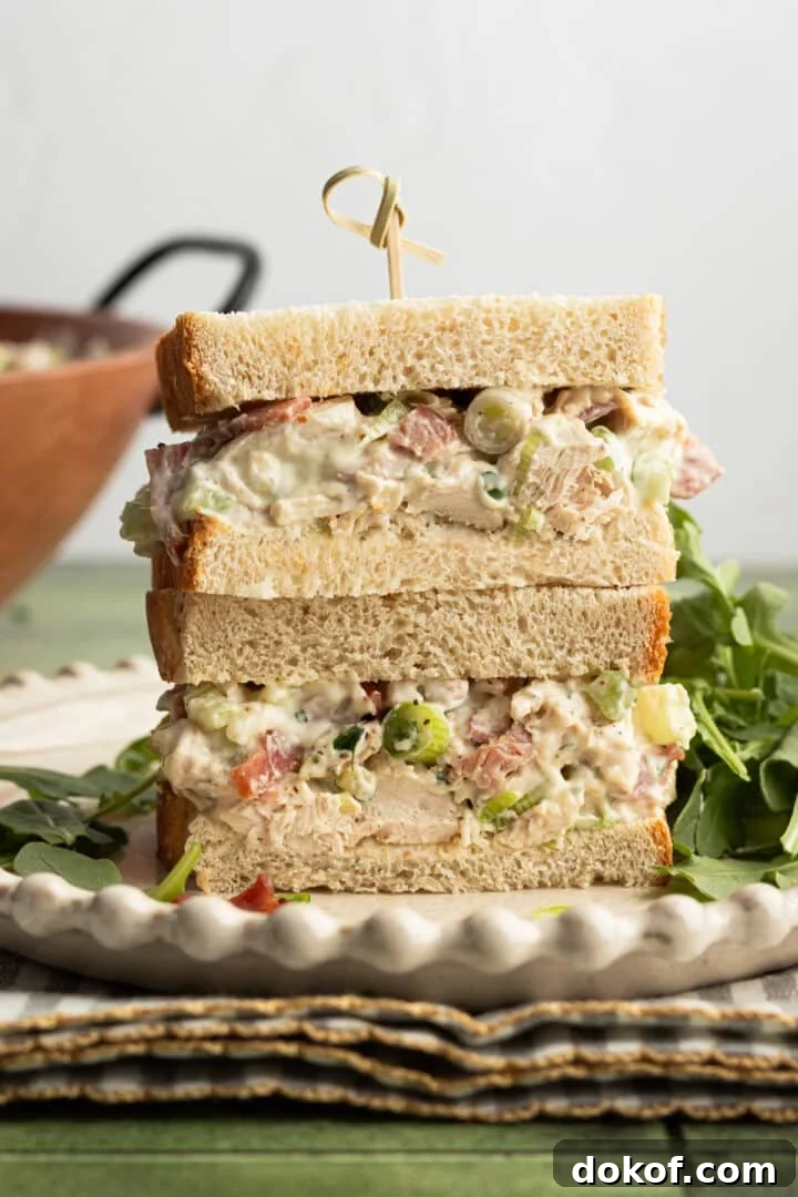 Ranch chicken salad in a sandwich, sliced in half.