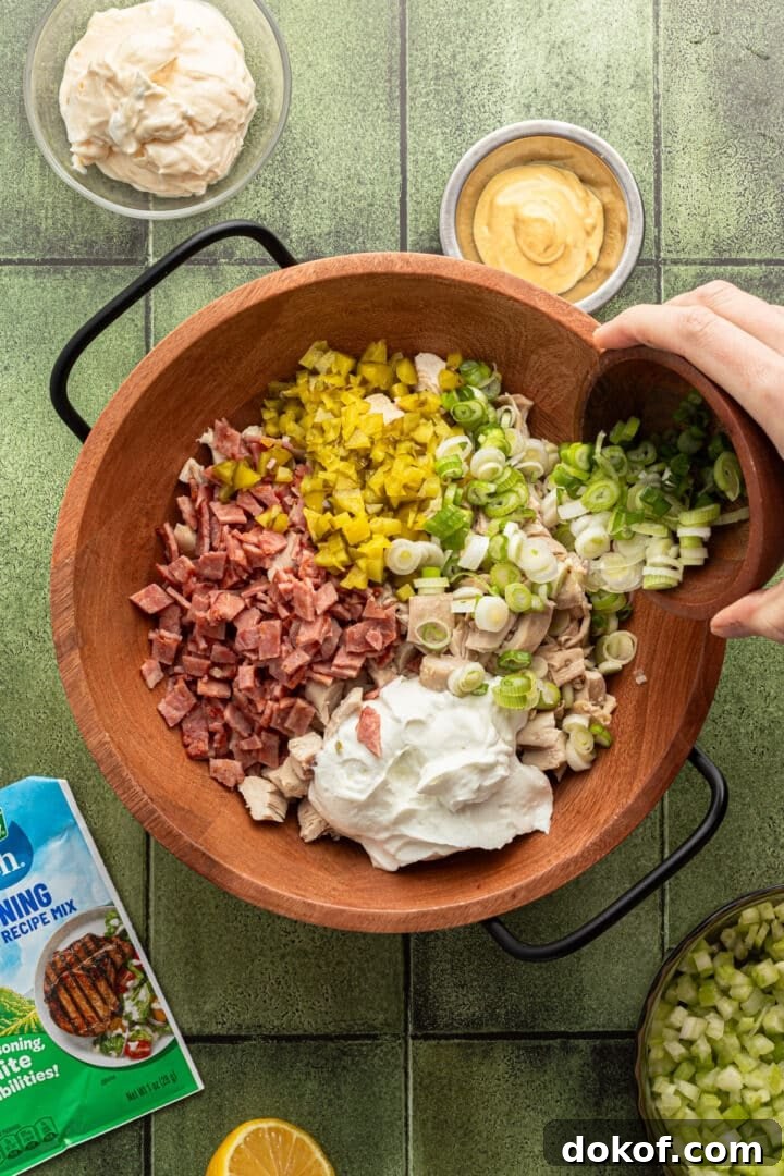 Ingredients for ranch chicken salad in a large wooden bowl