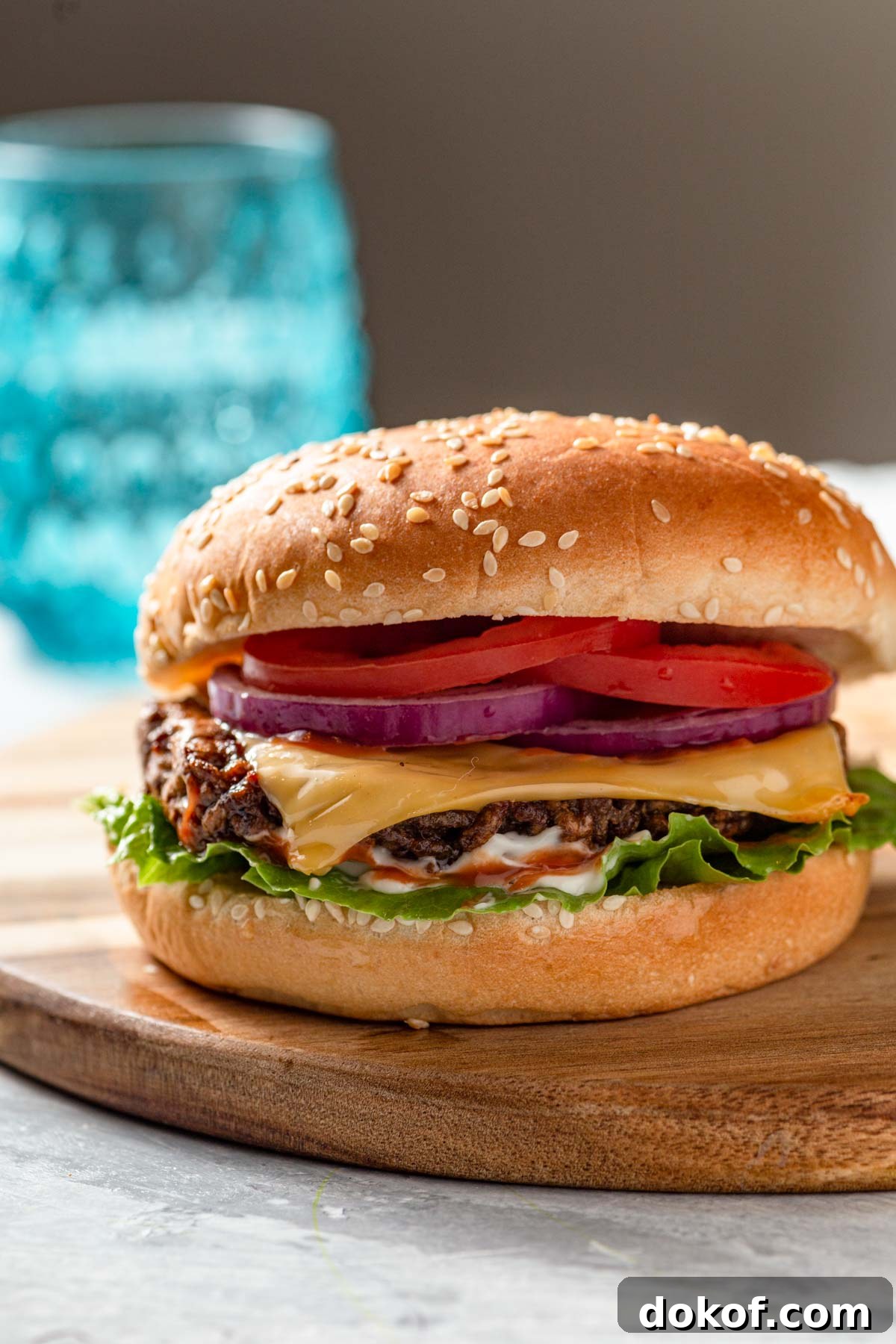air fruer frozen hamburgers with burger bun, lettuce and sliced onions and tomatoes
