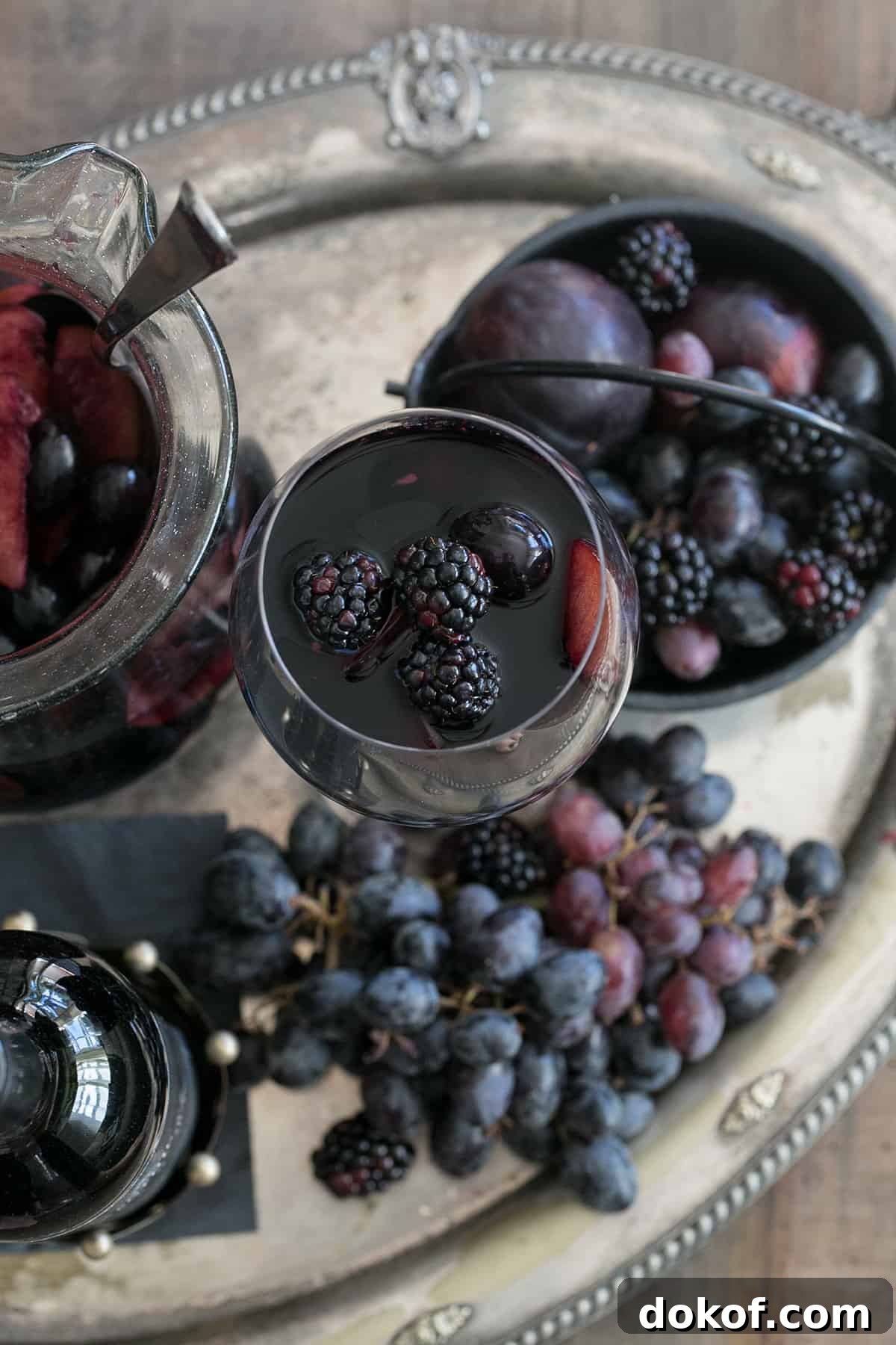 Halloween sangria on a platter with black grapes.