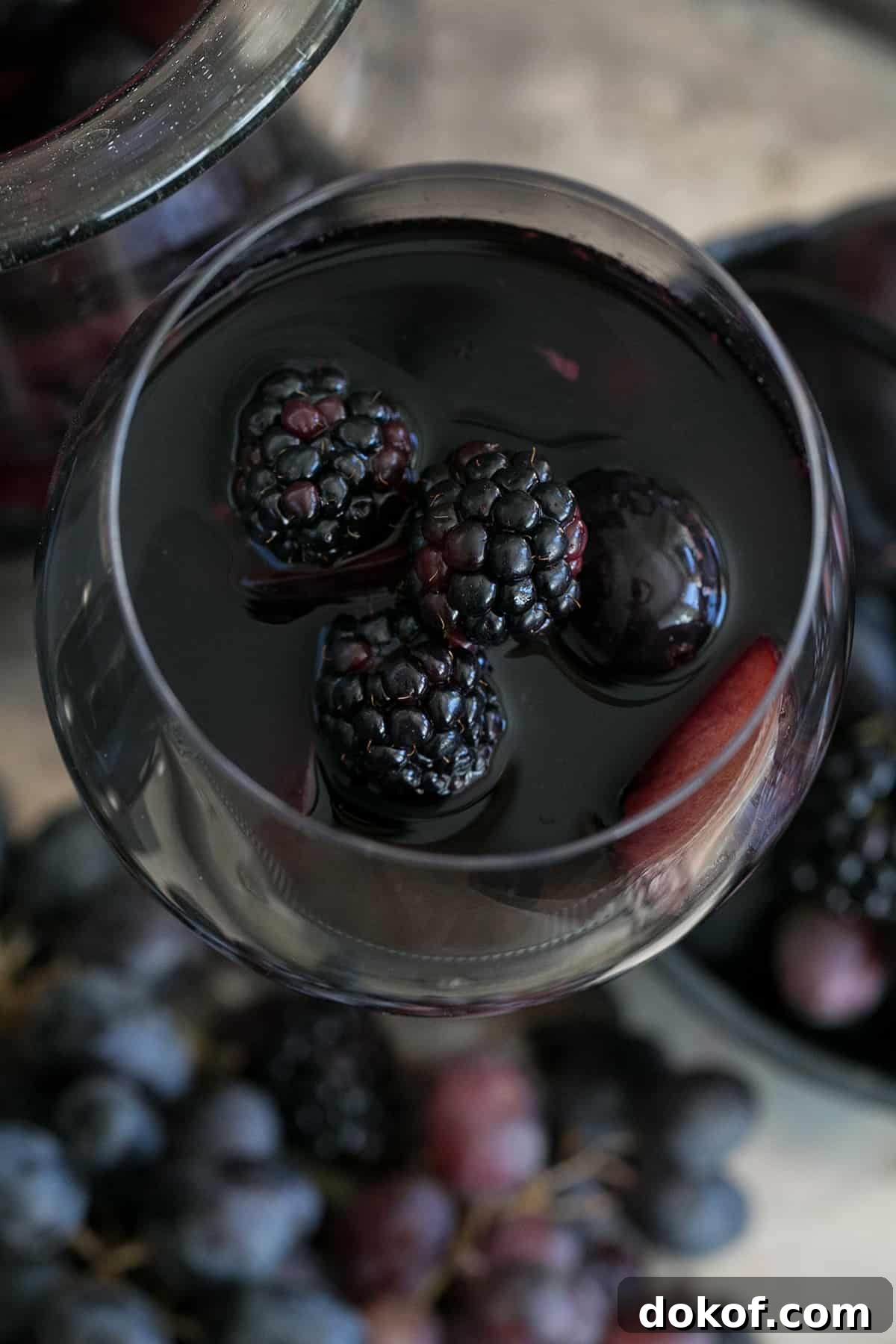 black sangria with blackberries in a wine glass.