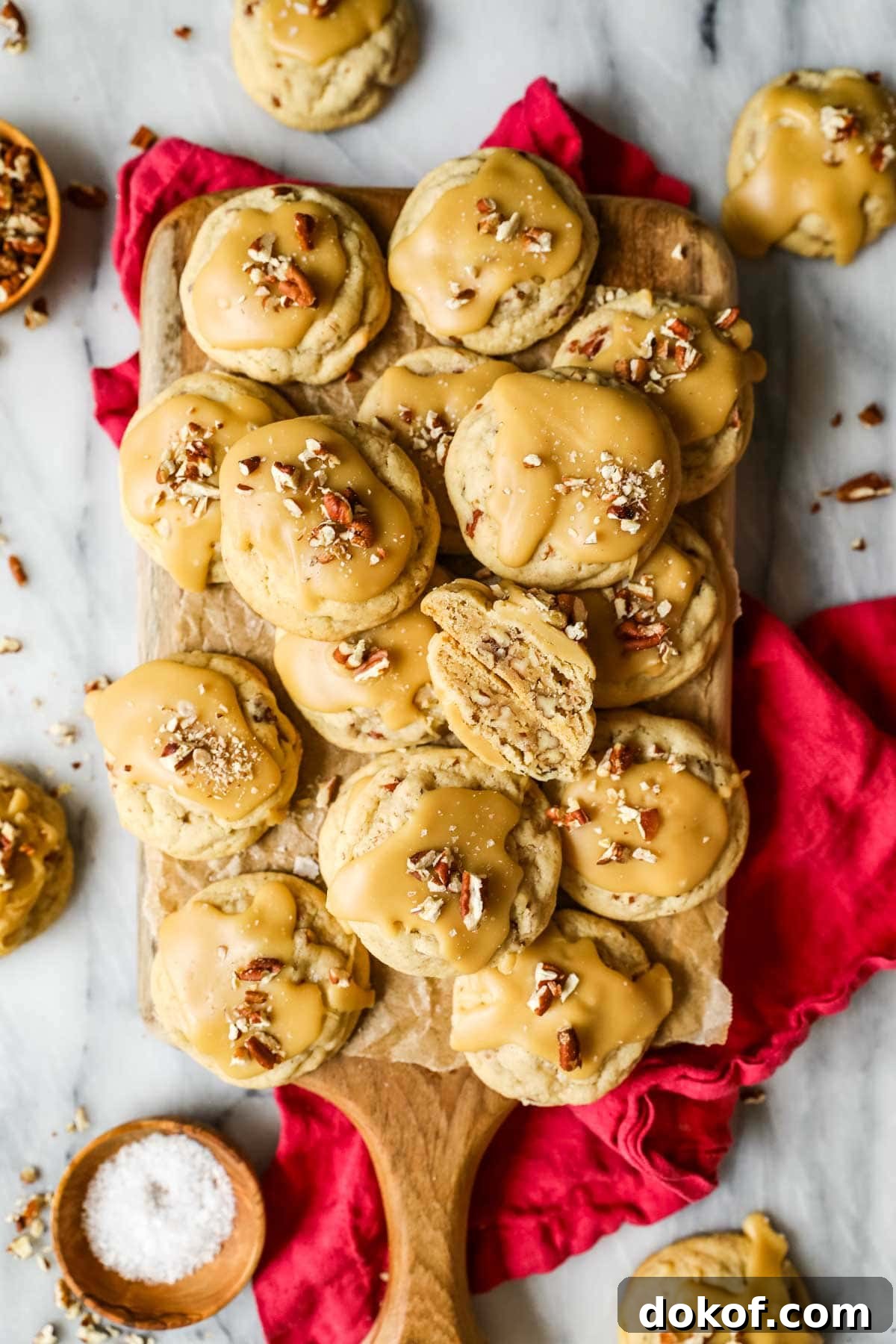 Pile of praline cookies with the center cookie cut in half to show the inside.