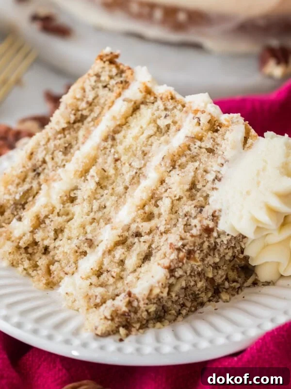 Slice of three layer butter pecan cake on a plate.