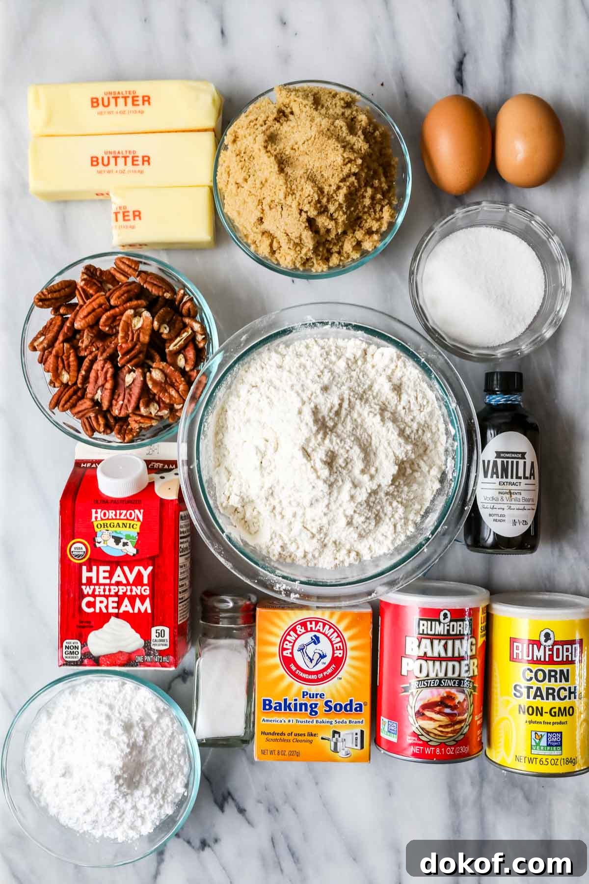 Overhead view of ingredients including pecans, brown sugar, eggs, and more.