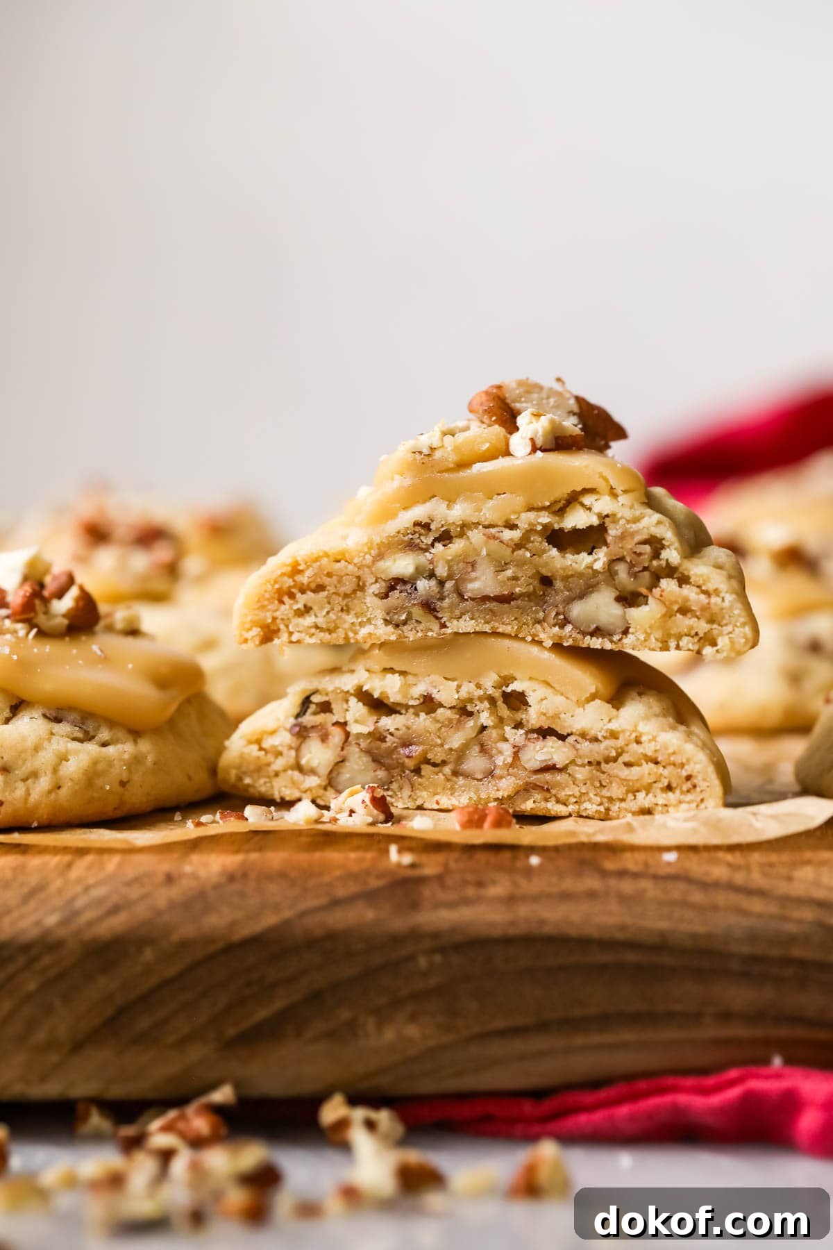 Two halves of a praline pecan cookie stacked on top of each other.