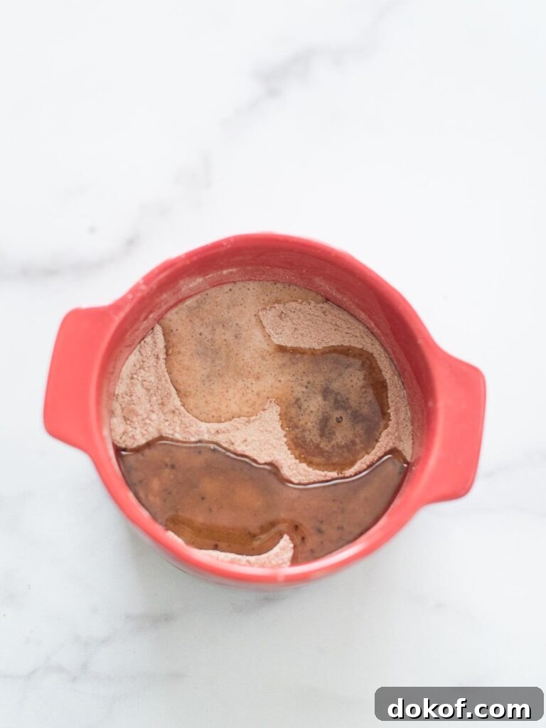 Quick Microwave Chocolate Mug Cake Recipe in 2 Minutes 12 wet ingredients added to dry ingredients in mug