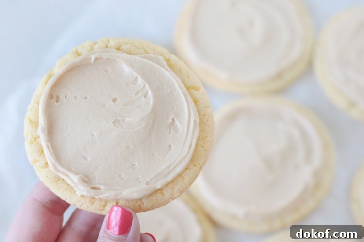 hand holding caramel sugar cookie