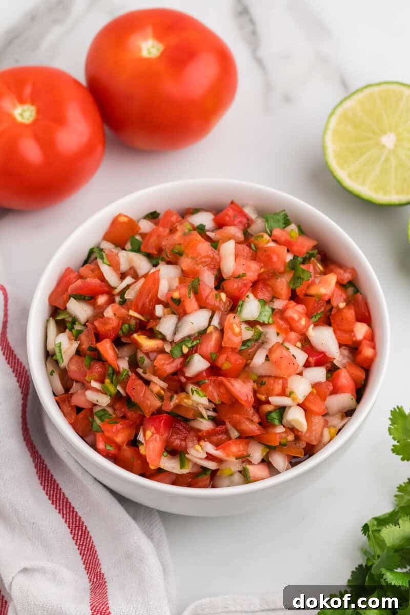 Authentic Pico de Gallo Recipe: Fresh Mexican Salsa Tutorial 7 closeup of the Pico de Gallo served in a white bowl.