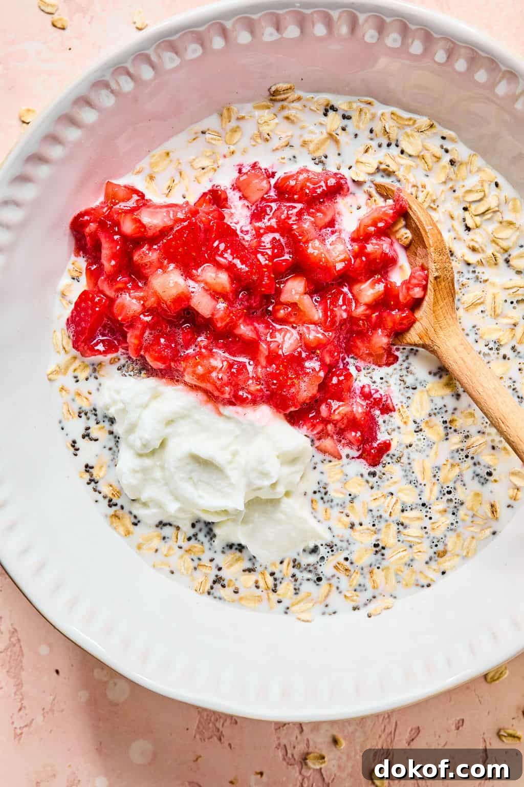 Strawberries, yogurt, maple syrup, and milk added to bowl