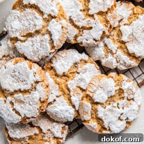 pile of peanut butter crinkle cookies on small antique wire cooling rack with handle