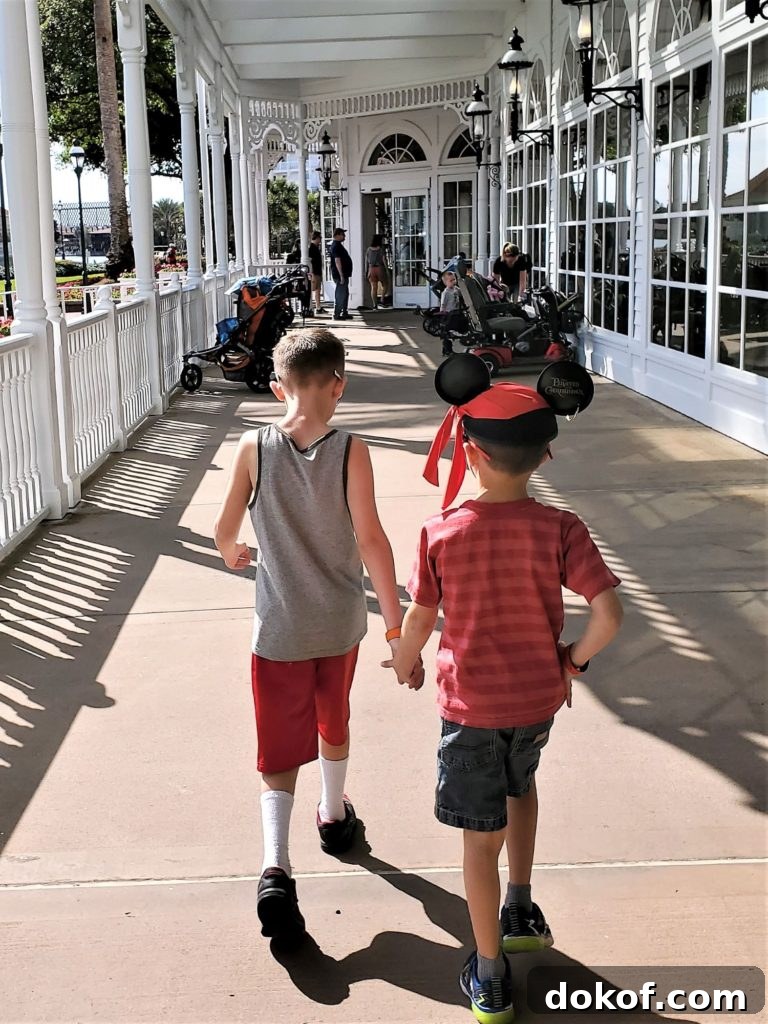 chase and wyatt holding hands while heading to breakfast at grand floridian cafe