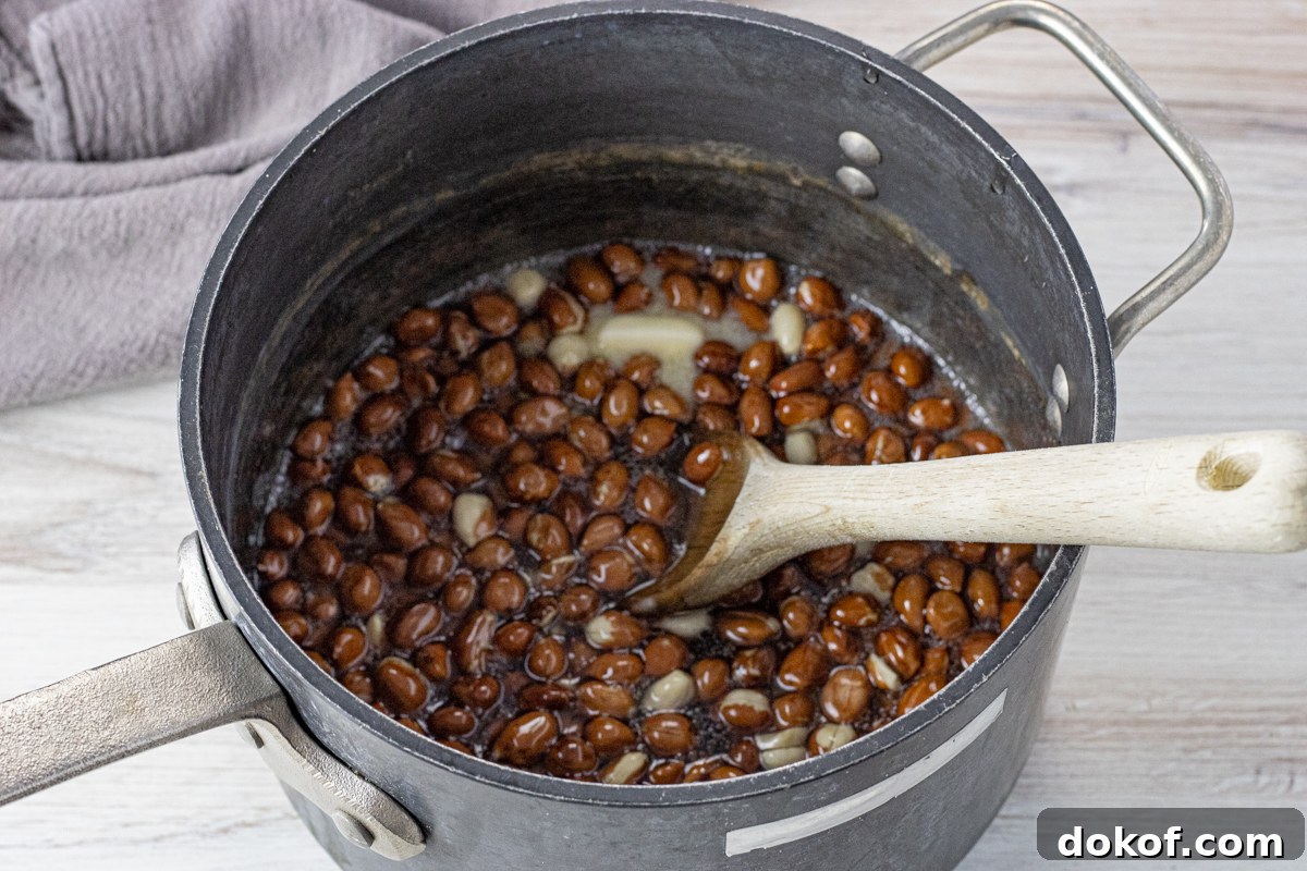 peanuts in a sugar corn syrup mixture in a large pot