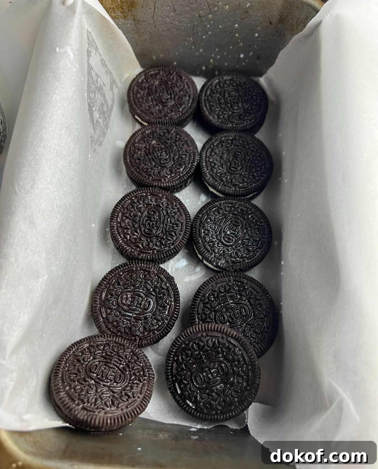 Oreos dipped in milk in a loaf pan.