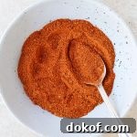 Homemade chicken taco seasoning in a bowl with a spoon.