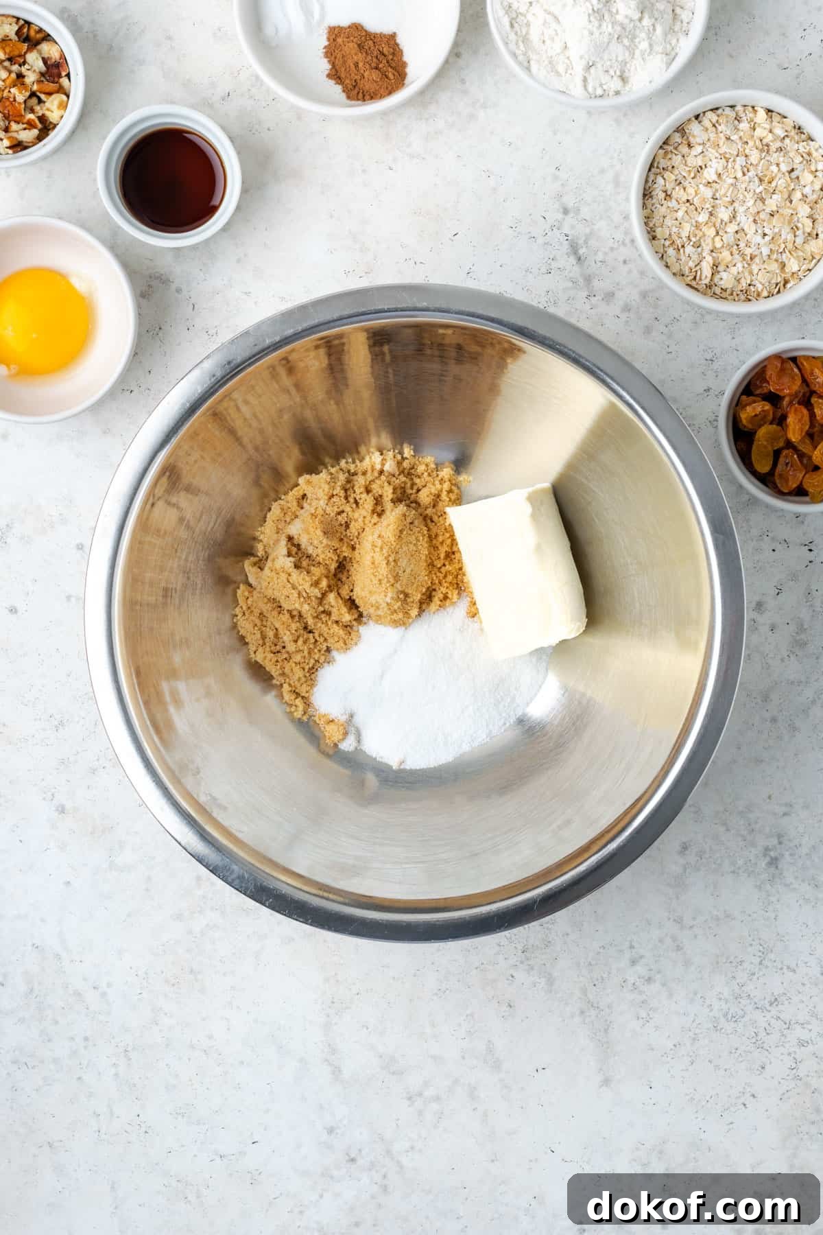 Brown sugar, white sugar and vegan butter combined in a metal mixing bowl. 