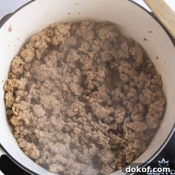 Browning sausage in a pot.