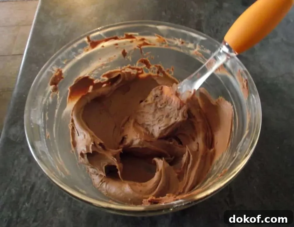 Mars Bar Cupcakes chocolate buttercream frosting in a glass bowl