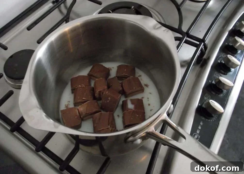 Mars Bars and milk in a saucepan on the hob