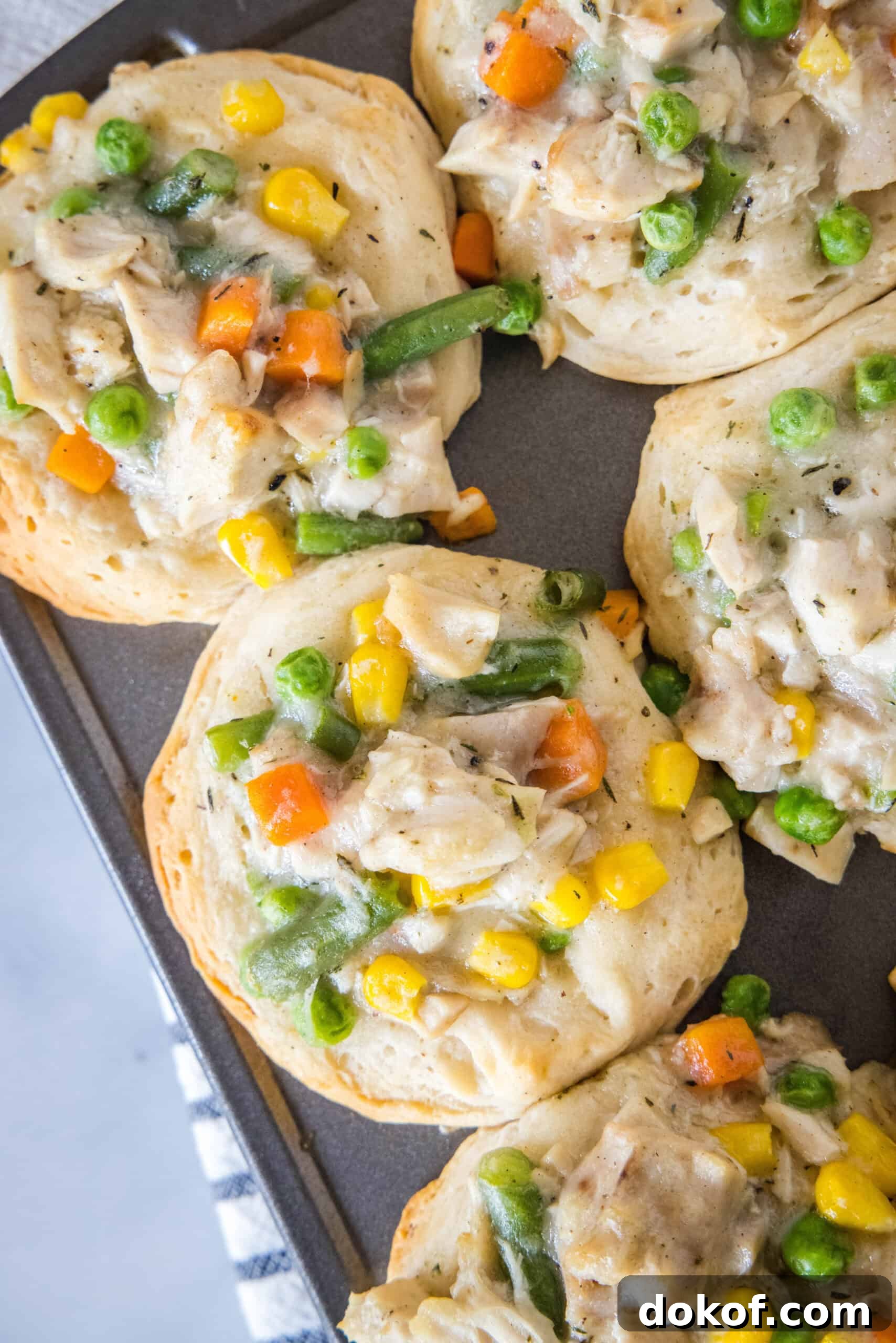 Overhead view of mini chicken pot pies in a muffin tin.