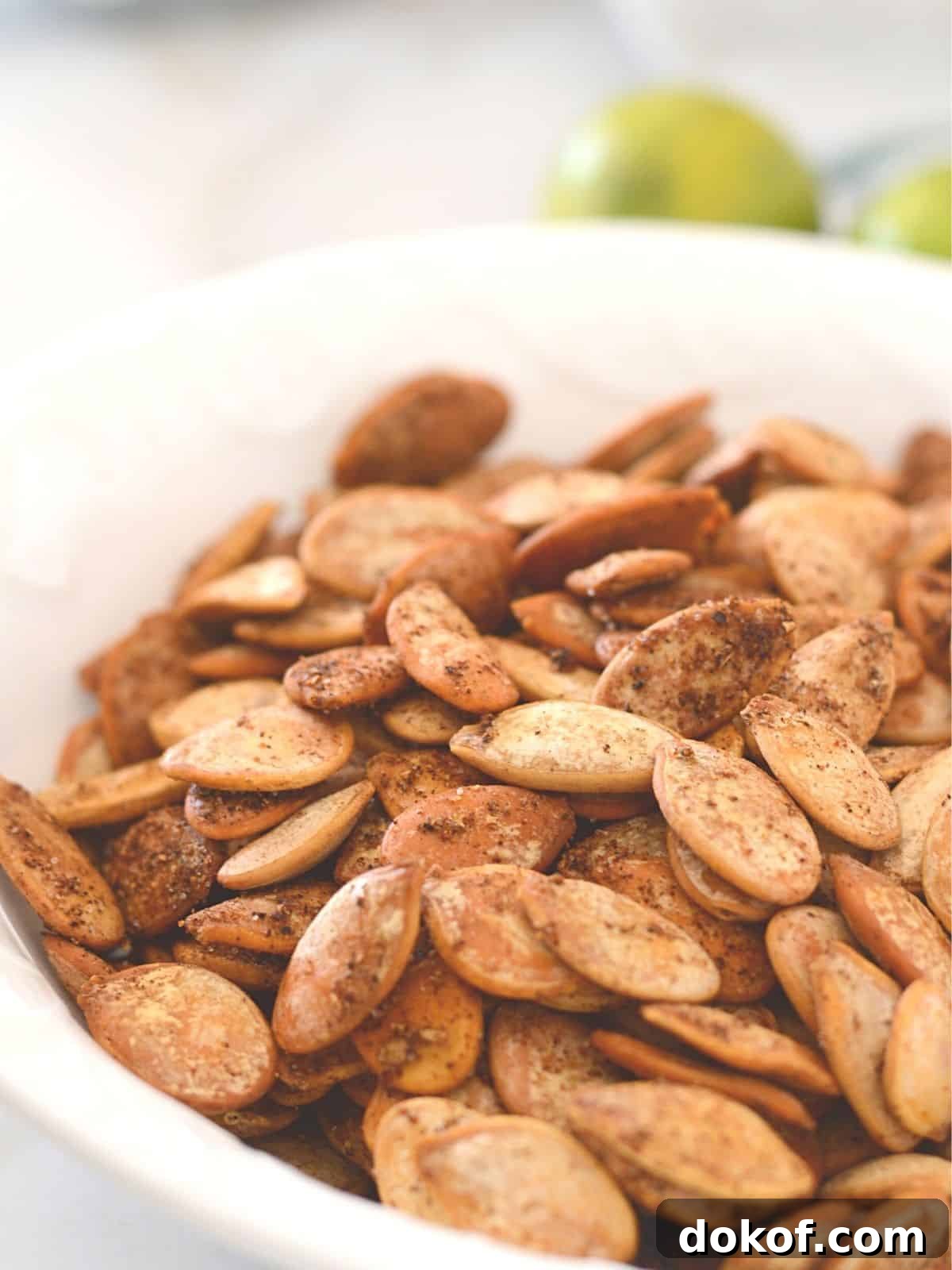 A close up look at a white plate with spicy roasted pumpkin seeds.