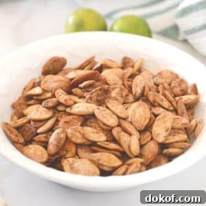 A close up look at a white plate with spicy roasted pumpkin seeds.