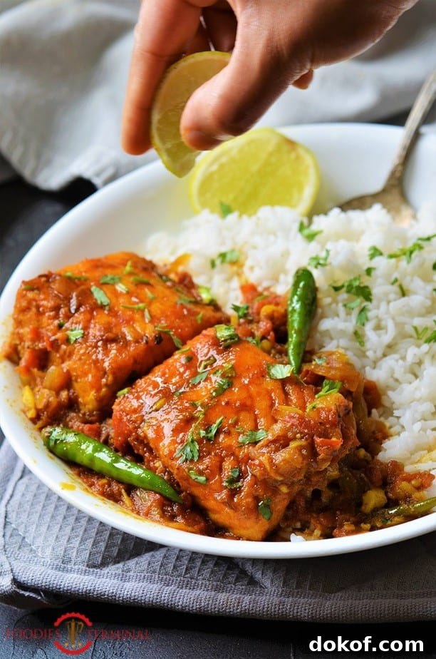 Salmon Curry Indian style served with white rice & green chilies