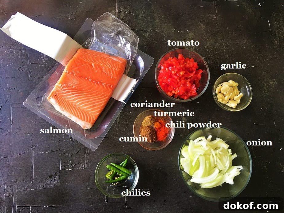Ingredients for easy Salmon curry in various bowls on a black surface