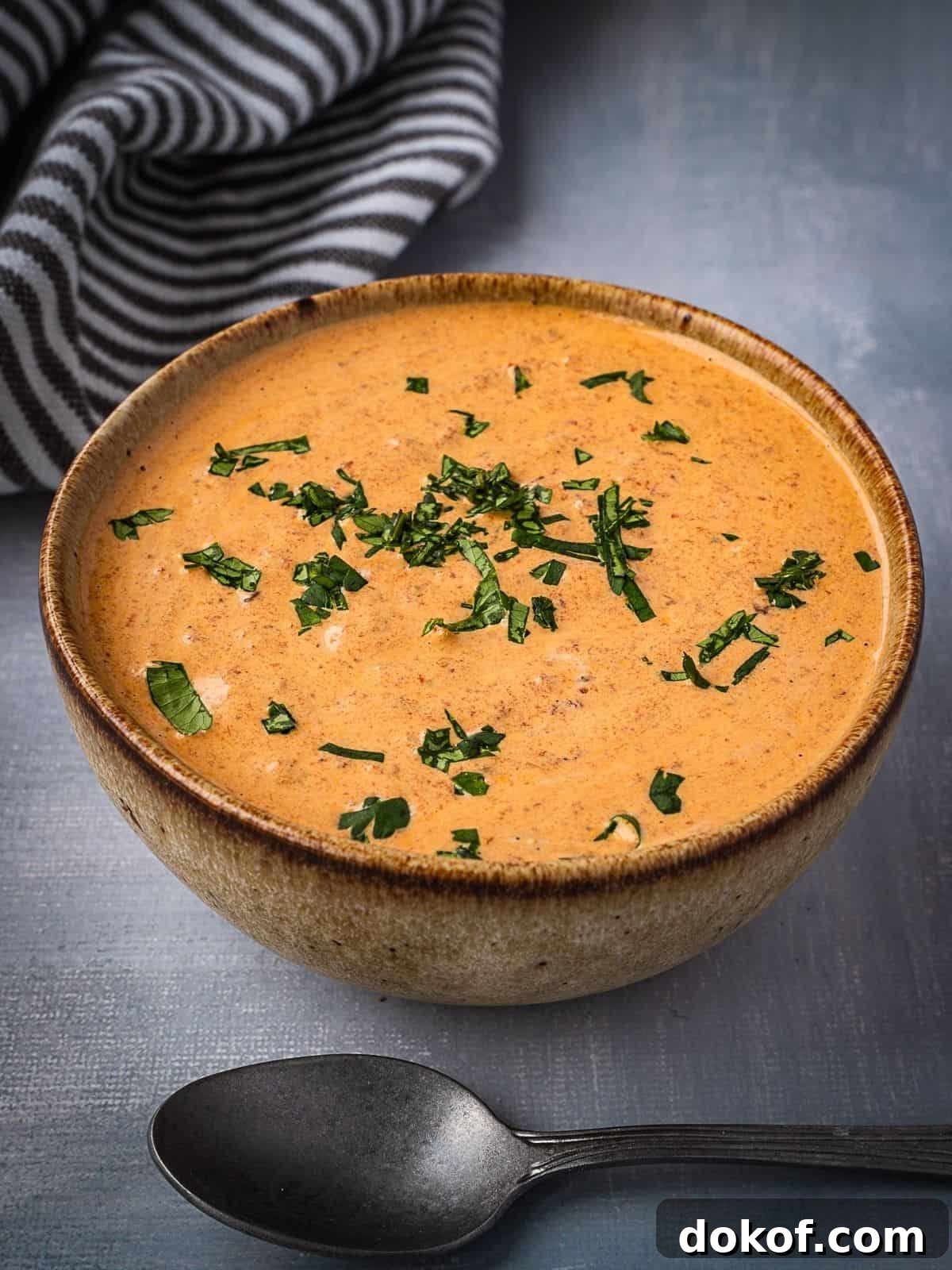 A bowl of creamy chipotle sauce garnished with cilantro.