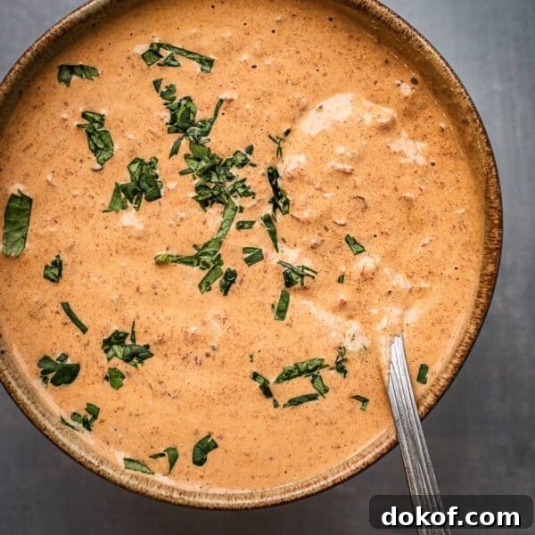 A bowl of creamy chipotle sauce garnished with cilantro.