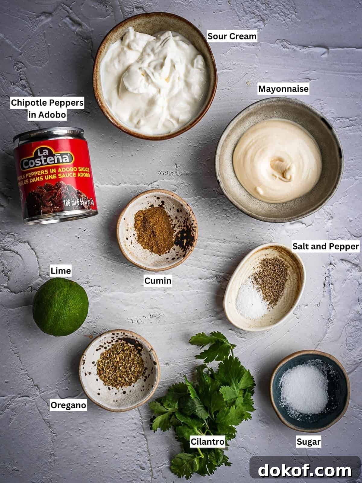 Creamy chipotle sauce recipe ingredients with labels on a board.