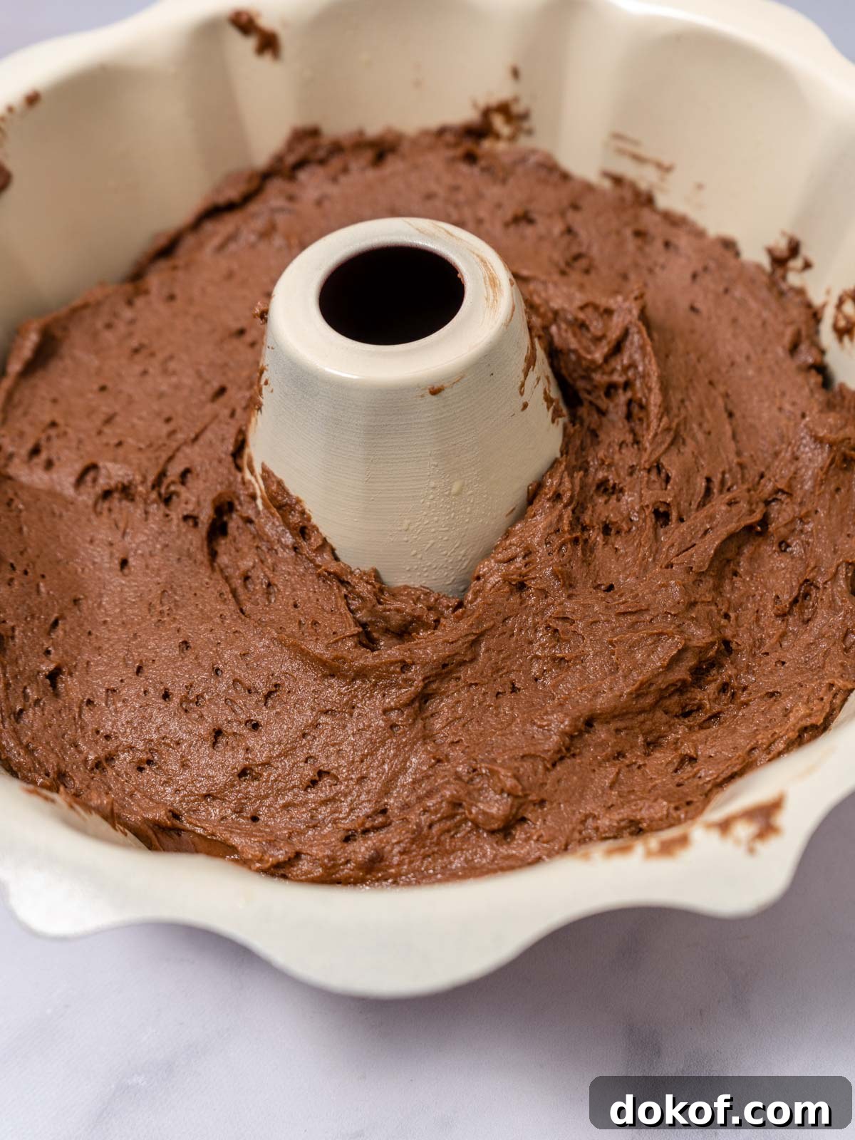 Chocolate cake batter in a bundt pan.