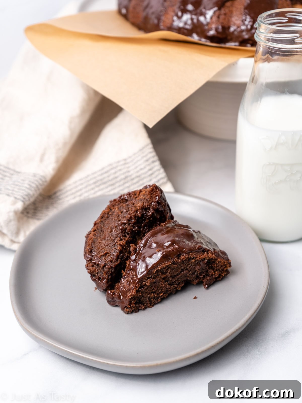 Two slices of chocolate cake on a plate.