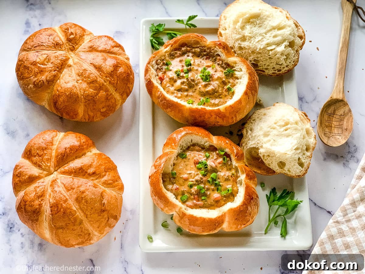 a serving platter of homemade Bread Bowls filled with Cheeseburger Soup